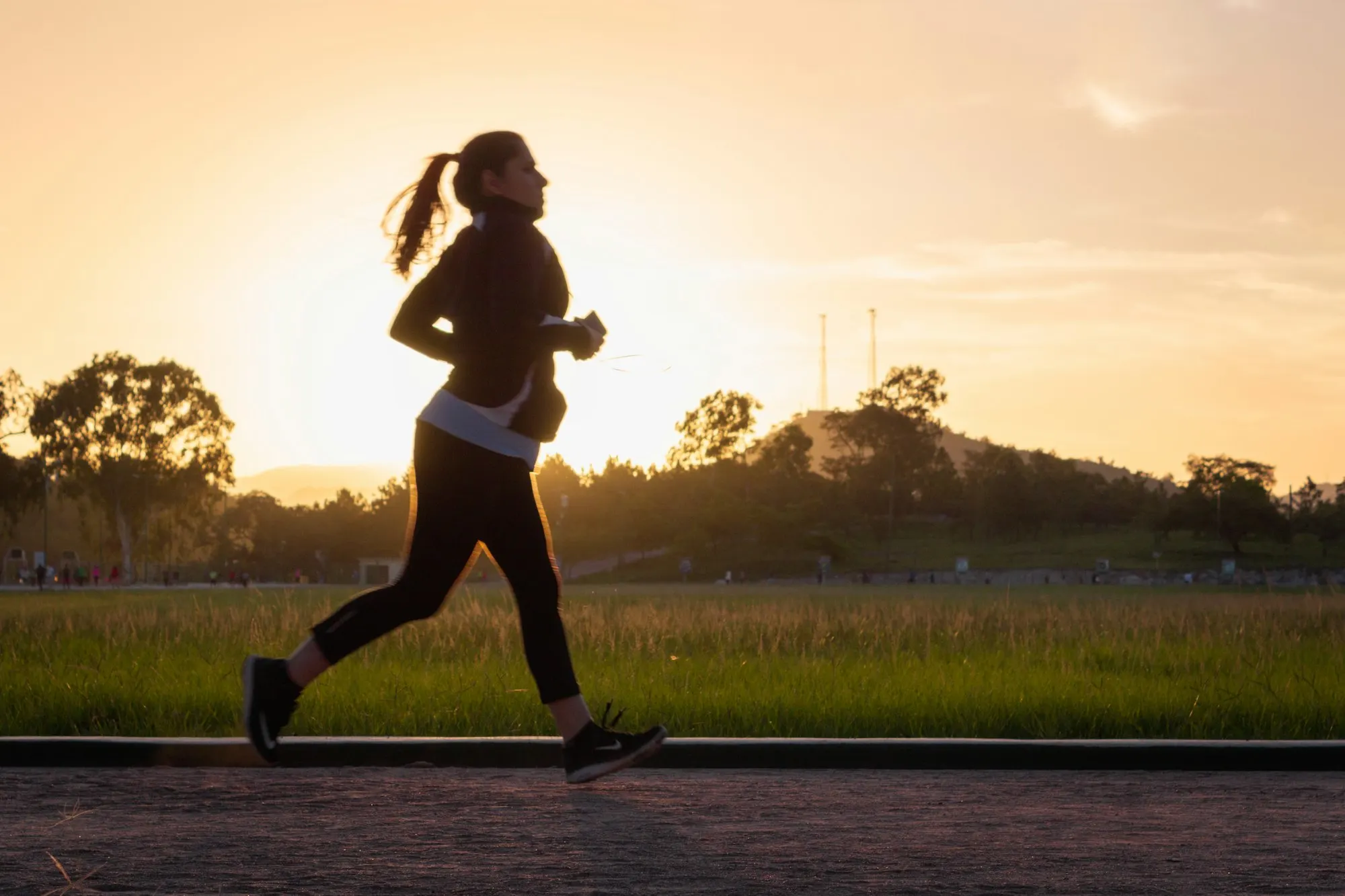 A woman running in golden-hour light