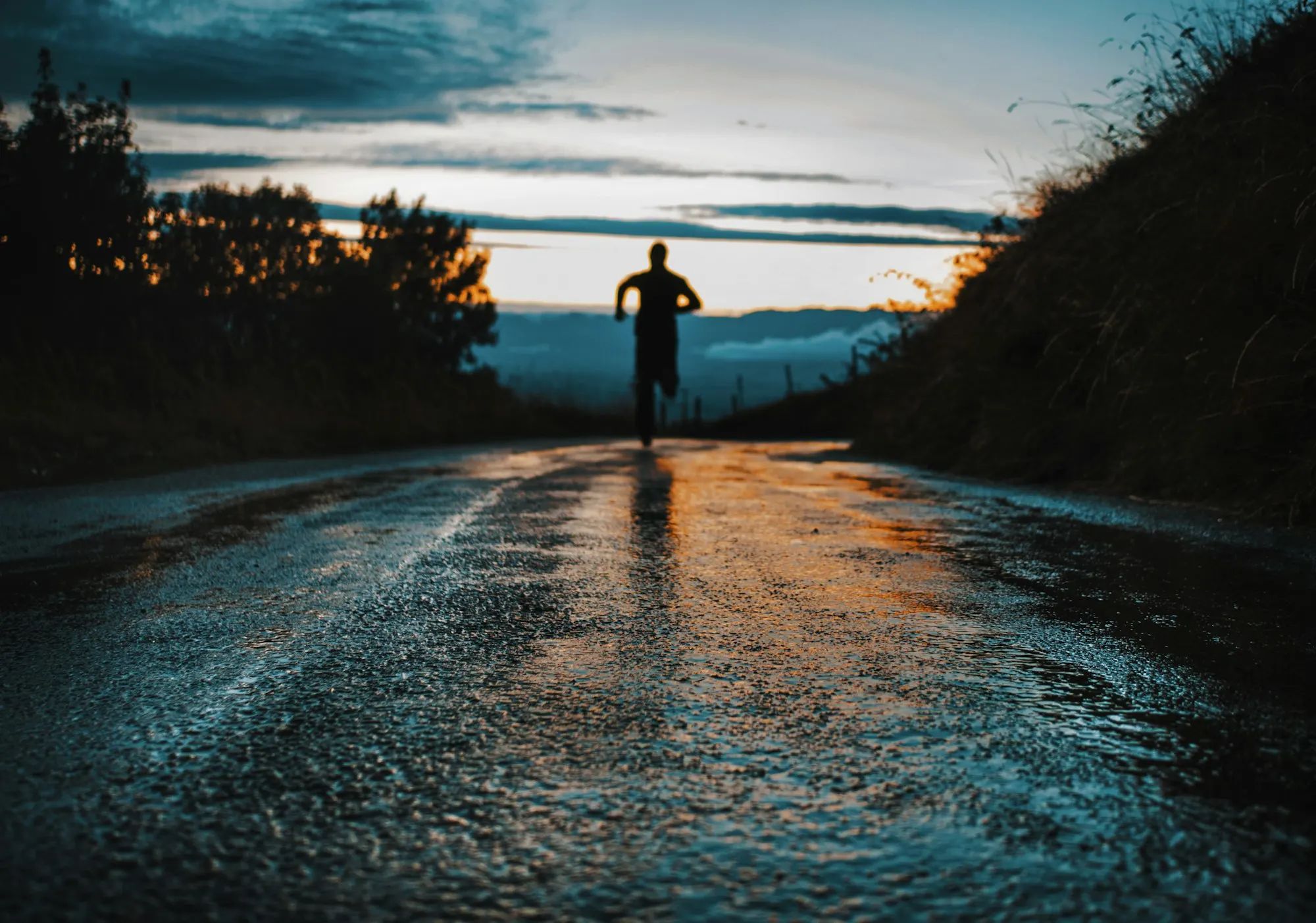 A runner in silhouette on a road