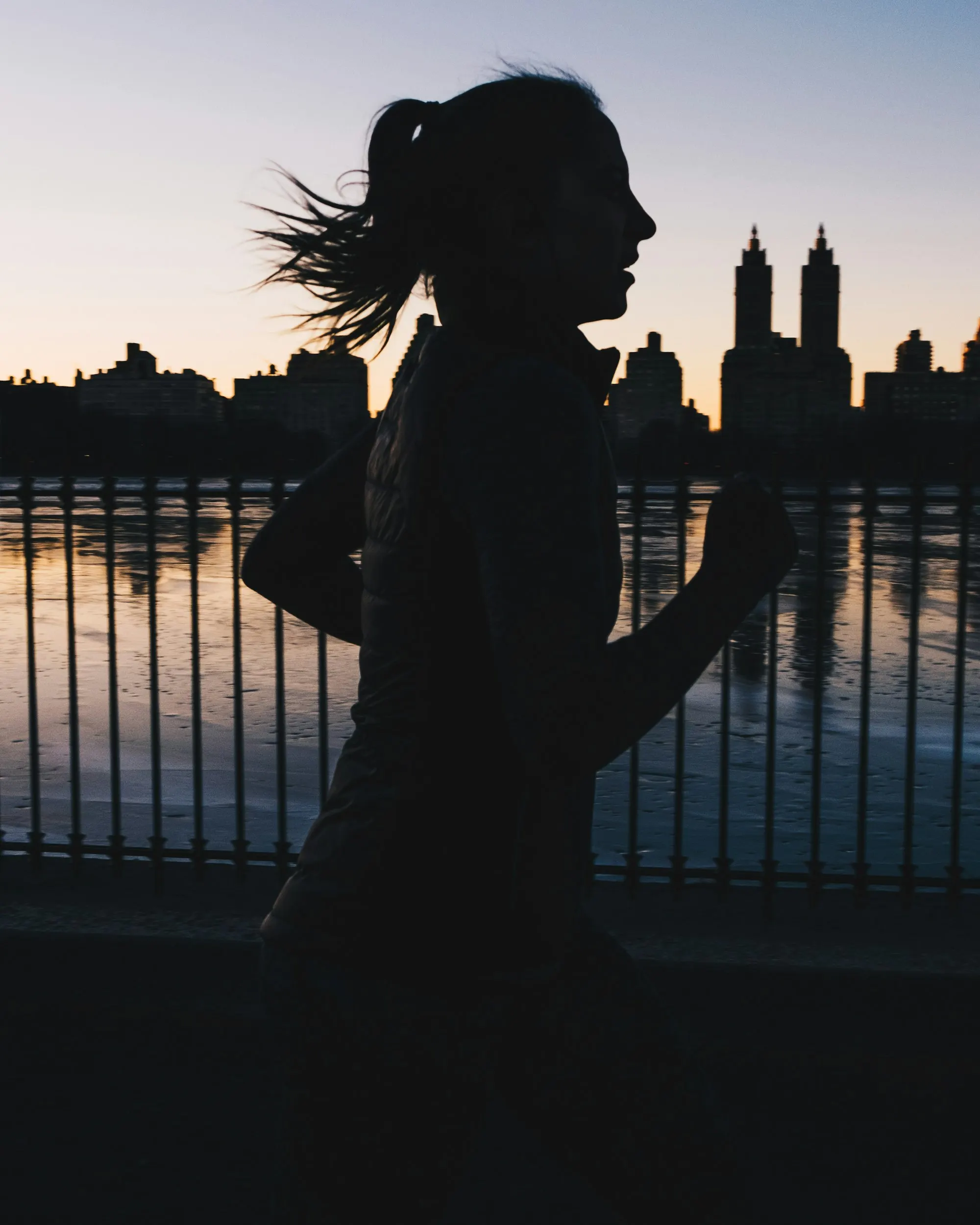 A woman running in silhouette