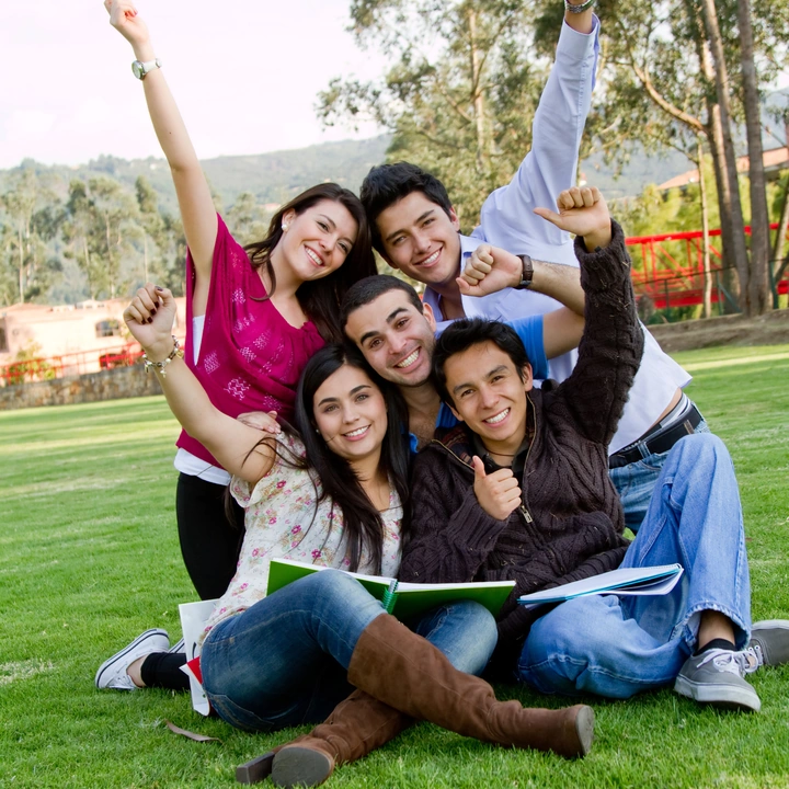 Students celebrating together in a park