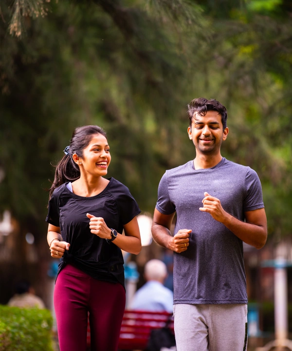 Two runners jogging in a park
